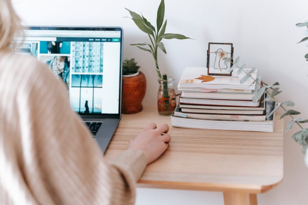 Crop remote employee working on laptop in house room